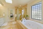 Masterbath with gorgeous glass step in shower and wonderful jetted soaking tub